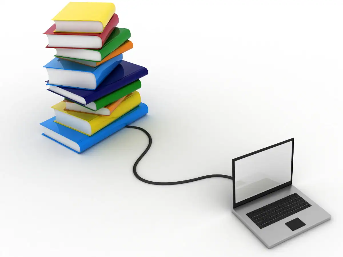 Böcker uppkopplade med kabel till en laptop som symboliserar digital utbildning och e-learning.